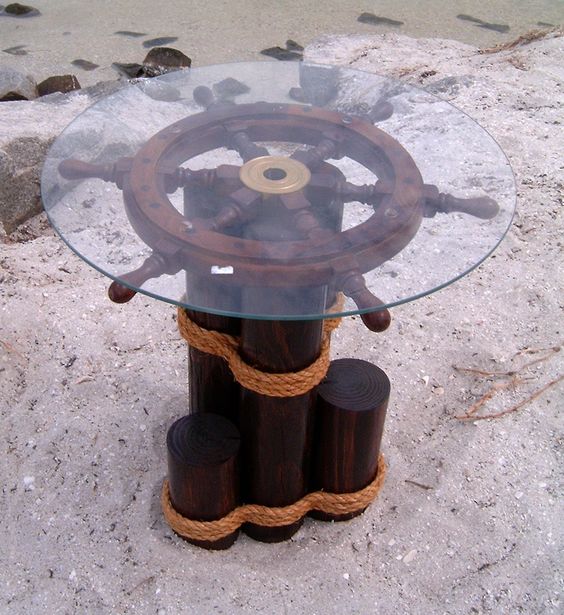glass top table built on ship wheel