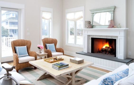 washed wood coffee table in front of a beach fireplace